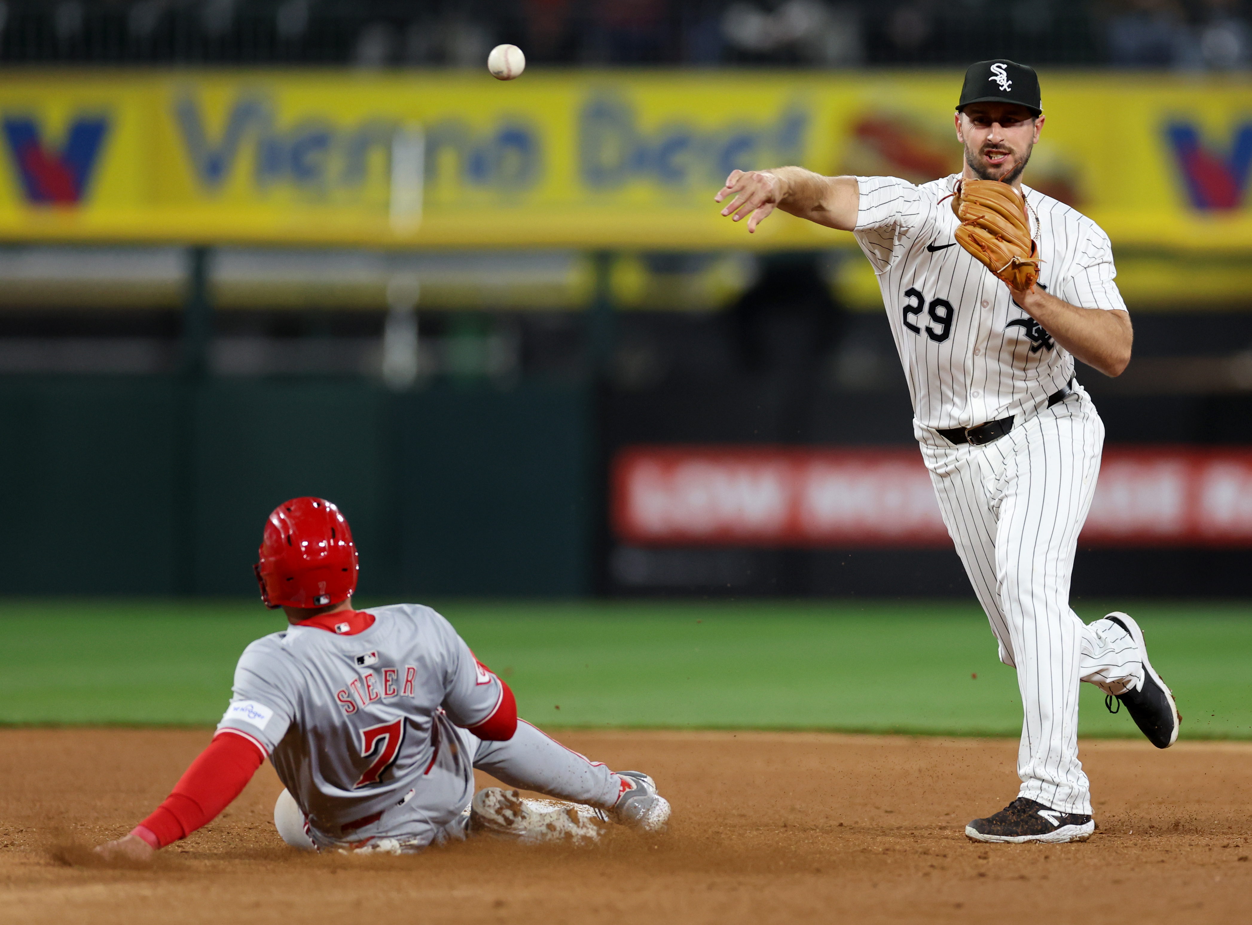 White Sox shortstop Paul DeJong throws to first base after forcing out the Reds' Spencer Steer at second base in the seventh inning on April 12, 2024, at Guaranteed Rate Field. (Chris Sweda/Chicago Tribune)