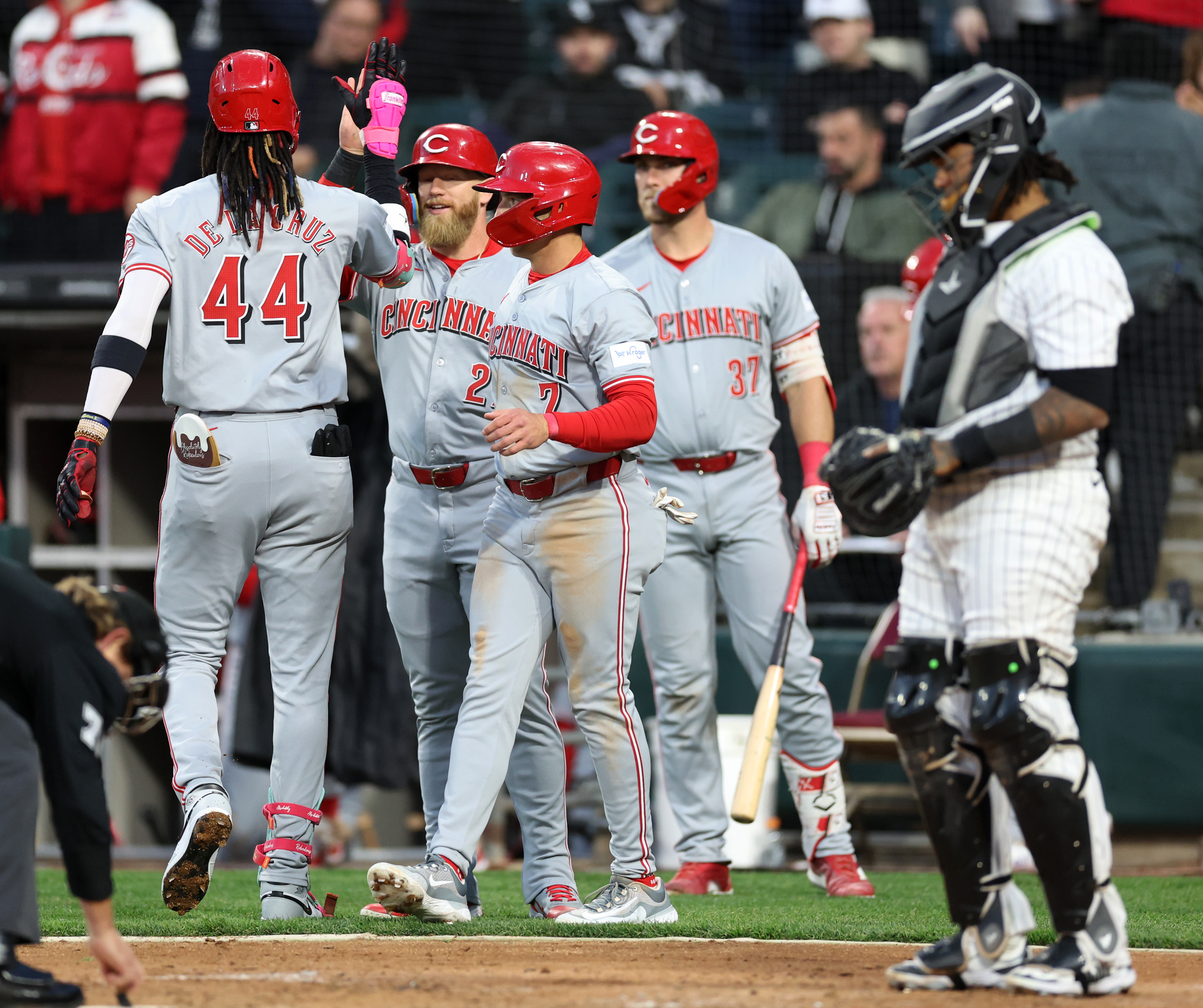 Reds shortstop Elly De La Cruz (44) is congratulated by teammates after hitting a three-run home run in the third inning against the White Sox on April 12, 2024, at Guaranteed Rate Field. (Chris Sweda/Chicago Tribune)