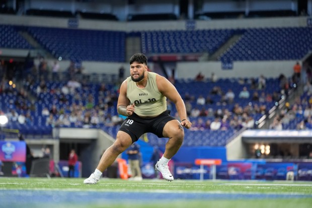 Washington offensive lineman Troy Fautanu runs a drill at the NFL combine on March 3, 2024, in Indianapolis. (AP Photo/Michael Conroy)