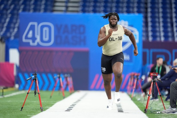 Penn State offensive lineman Olu Fashanu runs the 40-yard dash at the NFL combine on March 3, 2024, in Indianapolis. (AP Photo/Michael Conroy)