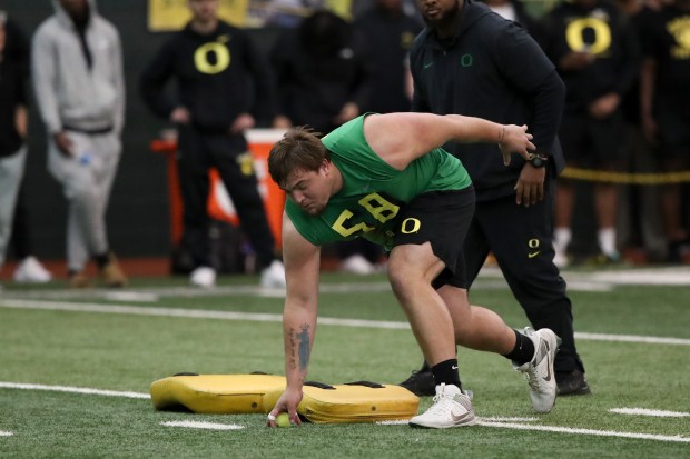 Offensive lineman Jackson Powers-Johnson participates in a position drill at Oregon pro day on March 12, 2024, in Eugene, Ore. (AP Photo/Amanda Loman)