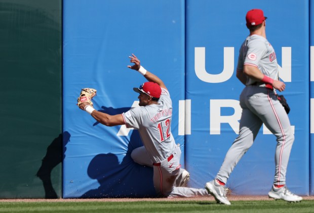 Reds centerfielder Bubba Thompson (12) hits the centerfield wall after catching a fly ball from White Sox catcher Martín Maldonado for an out in the eighth inning at Guaranteed Rate Field on April 13, 2024, in Chicago. (John J. Kim/Chicago Tribune)