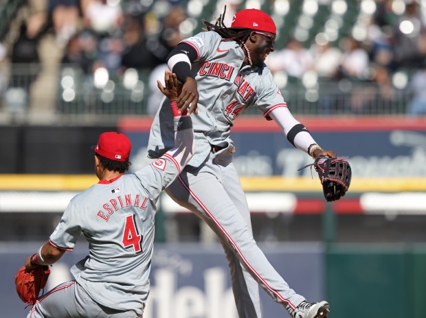 Reds second baseman Santiago Espinal (4) and shortstop Elly De La Cruz (44) celebrate a 5-0 win over the White Sox at Guaranteed Rate Field on April 13, 2024, in Chicago. (John J. Kim/Chicago Tribune)