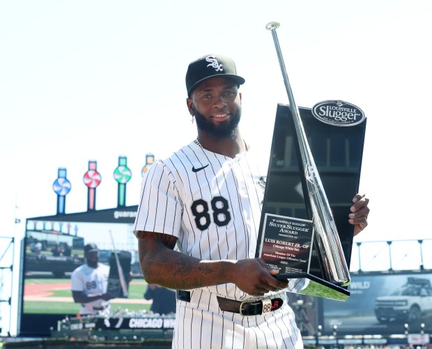 White Sox outfielder Luis Robert Jr. is presented with a 2023 Silver Slugger Award before a game against the Reds at Guaranteed Rate Field on April 13, 2024, in Chicago. (John J. Kim/Chicago Tribune)