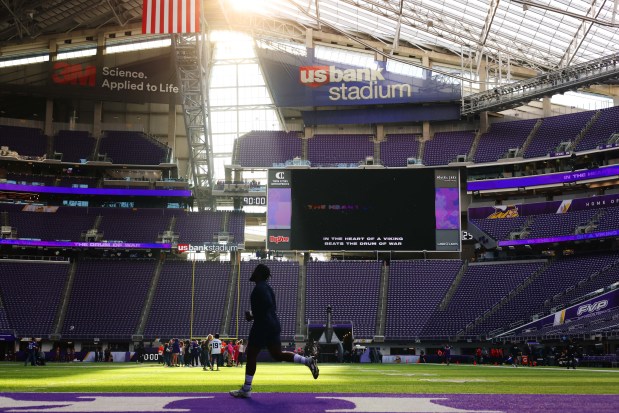 Chicago Bears defensive end Kingsley Jonathan sprints onto the field for warm ups before the start of a game between the Chicago Bears and the Minnesota Vikings at U.S. Bank Stadium on Oct. 9, 2022, in Minneapolis.(Stacey Wescott/Chicago Tribune)
