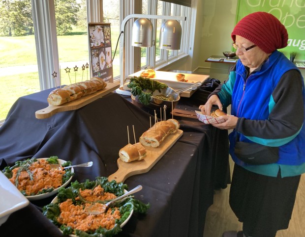 A diner helps herself to lunch at the grand opening of the Prairie at Brae Loch restaurant. (Steve Sadin/Lake County News-Sun)