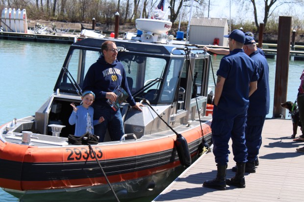 Maggie and David Majewski of Evanston step aboard a rapid response vessel to learn more about Coast Guard rescue operations during the Wilmette Harbor Coast Guard Station open house on April 13. (Gina Grillo/Pioneer Press)