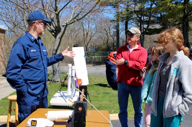 Sea Scouts Staff Officer John Norton shares information on the Sea Scouts program with members of the Bart family of Wilmette during Wilmette Harbor U.S. Coast Guard Station open house on April 13. (Gina Grillo/Pioneer Press)