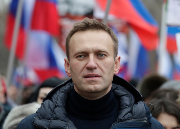 FILE - In this Sunday, Feb. 24, 2019 file photo, Russian opposition activist Alexei Navalny takes part in a march in memory of opposition leader Boris Nemtsov in Moscow, Russia. In August 2020, the opposition leader fell ill on a flight from Siberia to Moscow. The plane landed in the city of Omsk, where Navalny was hospitalized in a coma. Two days later, he was airlifted to Berlin, where he recovered. (AP Photo/Pavel Golovkin, File)