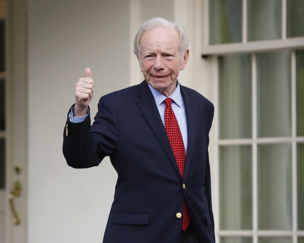 Former Connecticut Sen. Joe Lieberman gives a thumbs-up as he leaves the West Wing of the White House in Washington, Wednesday, May 17, 2017.
