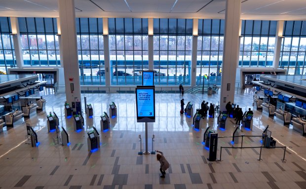 Passengers move about a spacious Terminal B of New York's LaGuardia Airport, March 24, 2021, in New York. The terminal was opened on June 13, 2020, as part of a challenging architectural plan that is expanding the airport on no more acreage than before. (Craig Ruttle/AP)