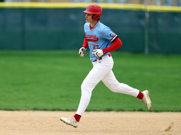 West Aurora's Carson Bantz (23) rounds the basses after his fist inning home run during a rain shortened Southwest Prairie Conference game against Yorkvilles in Aurora on Thursday, April 18, 2024. H. Rick Bamman / For the Beacon-News