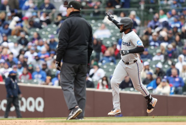 Marlins designated hitter Bryan De La Cruz, right, rounds the bases after hitting a two-run home run in the ninth inning against the Cubs at Wrigley Field on April 20, 2024, in Chicago. The home run resulted in a 3-2 Marlins win. (John J. Kim/Chicago Tribune)