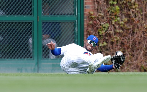 Cubs left fielder Alexander Canario lifts his glove after making a leaping catch for an out against the Marlins in the first inning on April 20, 2024, at Wrigley Field. (John J. Kim/Chicago Tribune)