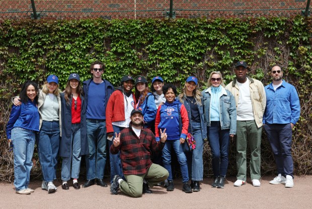 Cast members of the show, "The Bear," gather for pictures in the outfield before a game between the Cubs and Marlins at Wrigley Field on April 20, 2024, in Chicago. (John J. Kim/Chicago Tribune)