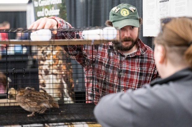 Izaak Walton League member Scott Palla stands near a cage containing Bobwhite Quails as he speaks with visitors during the 16th annual Recycling and Waste Reduction District of Porter County Earth Day Program on Saturday, April 20, 2024. (Kyle Telechan/for the Post-Tribune)