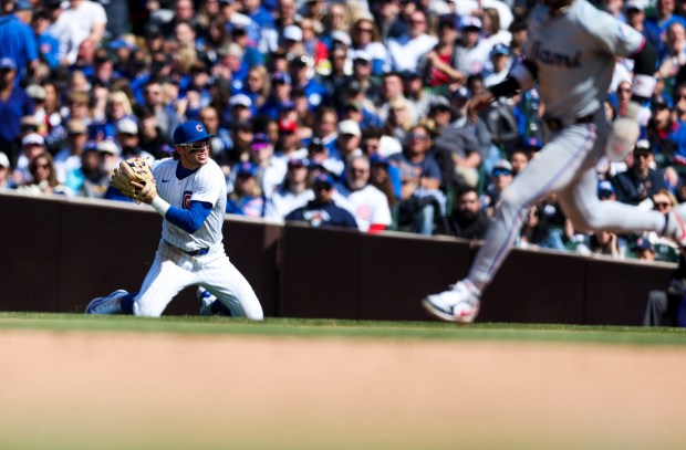 Chicago Cubs second base Nico Hoerner (2) throws to first base from his knees after fielding a grounder during the seventh inning against the Miami Marlins at Wrigley Field on April 21, 2024. (Eileen T. Meslar/Chicago Tribune)