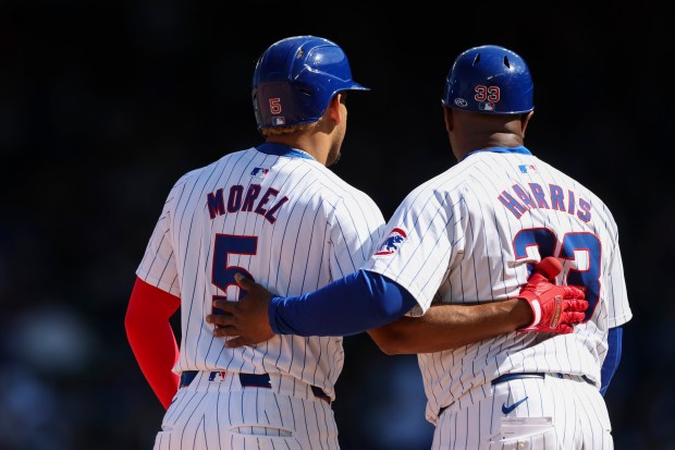 Chicago Cubs third base Christopher Morel (5) speaks to Chicago Cubs third base coach Willie Harris (33) after Morel hit a double during the seventh inning against the Miami Marlins at Wrigley Field on April 21, 2024. (Eileen T. Meslar/Chicago Tribune)