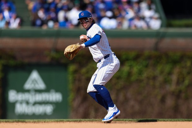 Chicago Cubs second base Nico Hoerner (2) looks to throw to first base after fielding the ball during the eighth inning against the Miami Marlins at Wrigley Field on April 21, 2024. (Eileen T. Meslar/Chicago Tribune)