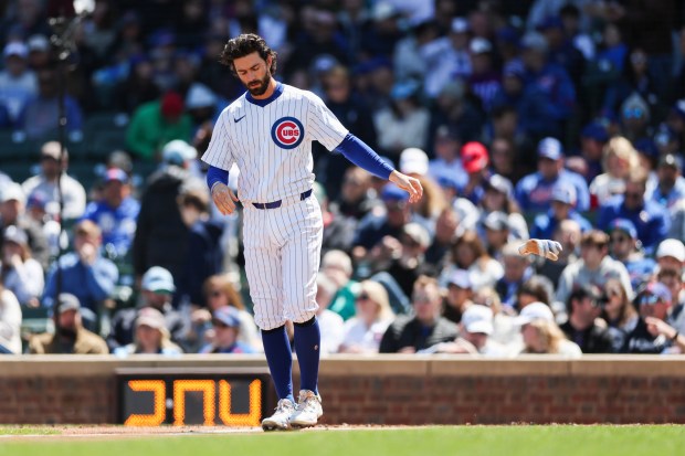 Chicago Cubs shortstop Dansby Swanson (7) throws his gloves on the field after striking out during the first inning against the Miami Marlins at Wrigley Field on April 21, 2024. (Eileen T. Meslar/Chicago Tribune)