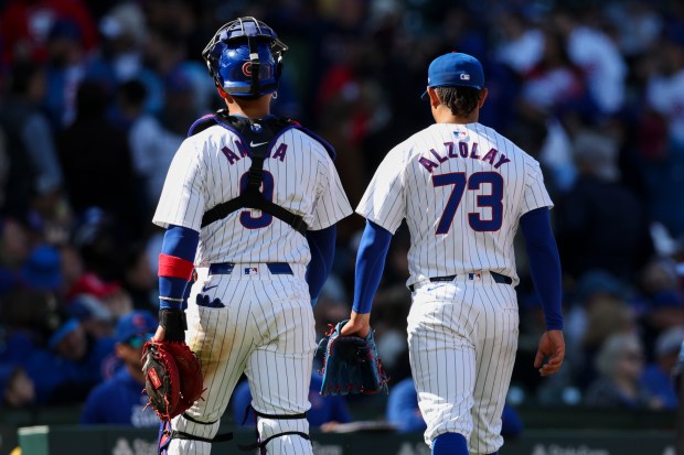 Chicago Cubs catcher Miguel Amaya (9) and pitcher Adbert Alzolay (73) walk to the dugout after the top of the eighth inning against the Miami Marlins at Wrigley Field on April 21, 2024. (Eileen T. Meslar/Chicago Tribune)
