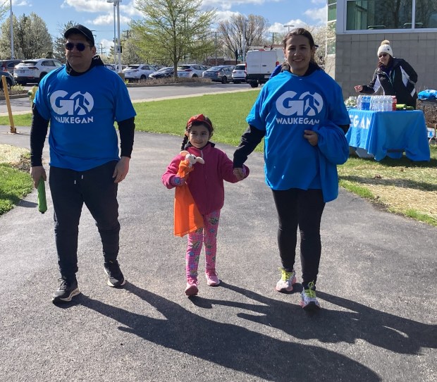 Starting their walk are, from left, Gustavo Gonzalez, Isabella Gonzalez and Diana Ballen. (Steve Sadin/Lake County News-Sun)