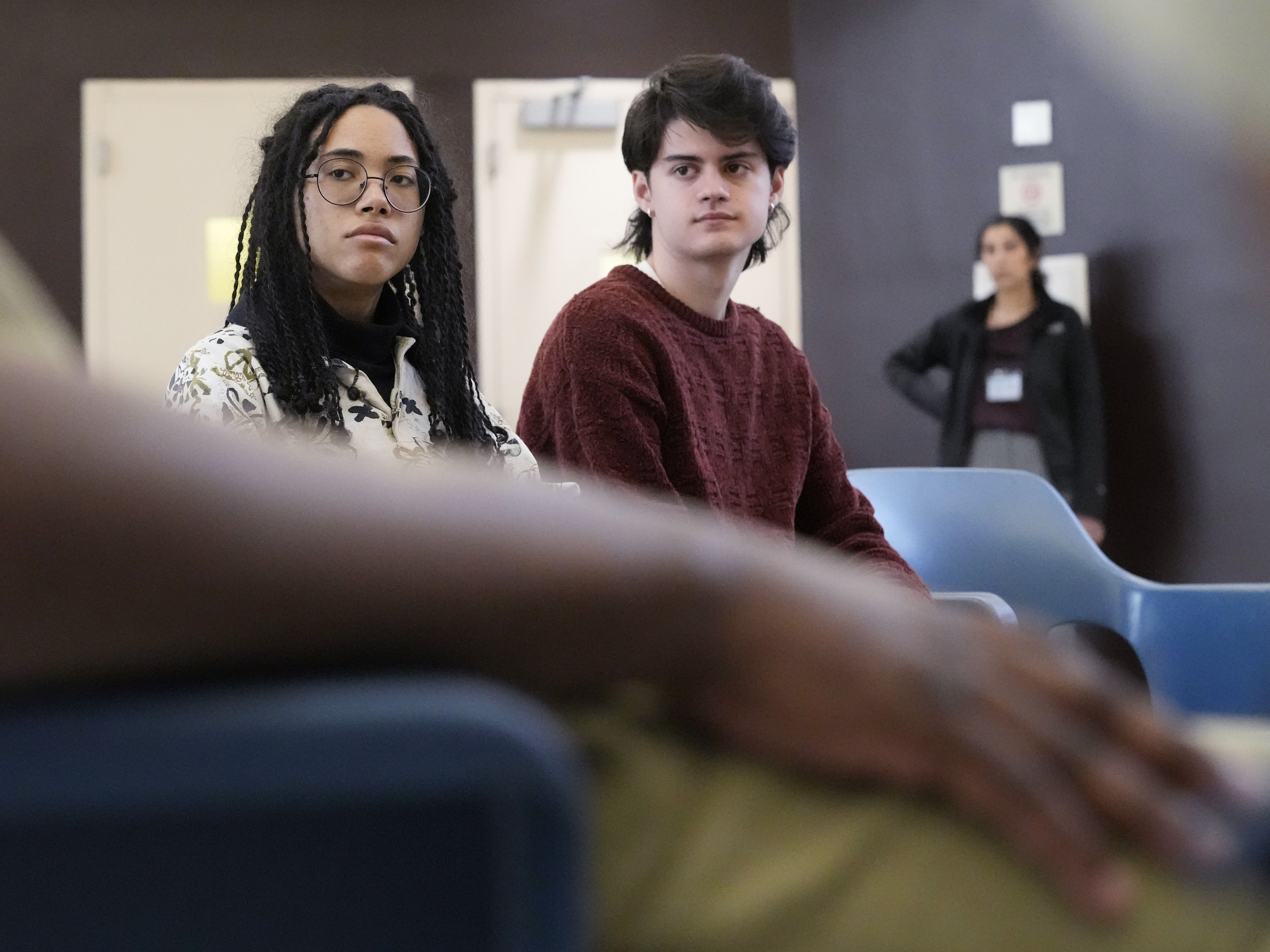 DePaul students Seven Clark, left, and Max Rocchio listens to...