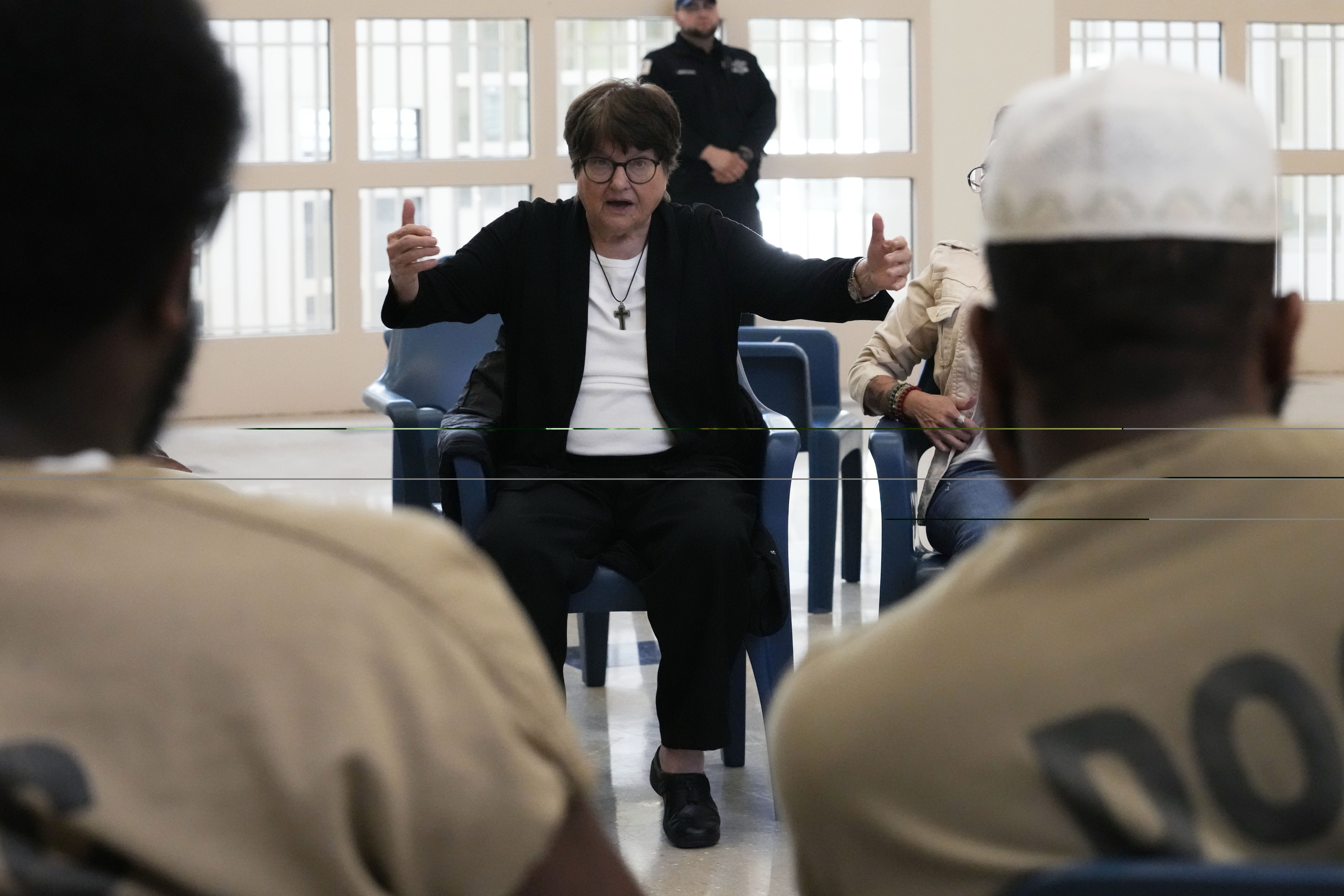 Sister Helen Prejean talks to detainees during a book club...