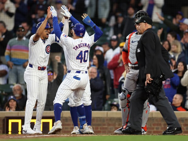 Chicago Cubs rightfielder Mike Tauchman (40) is congratulated by teammates Christopher Morel (left) and Dansby Swanson after Tauchman hit a 3-run home run in the first inning of a game against the Houston Astros at Wrigley Field in Chicago on April 23, 2024. (Chris Sweda/Chicago Tribune)