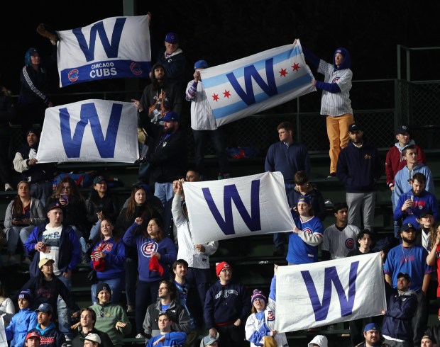 Chicago Cubs fans in the left field bleachers wave their W flags after a Cubs victory over the Houston Astros at Wrigley Field in Chicago on April 23, 2024. (Chris Sweda/Chicago Tribune)