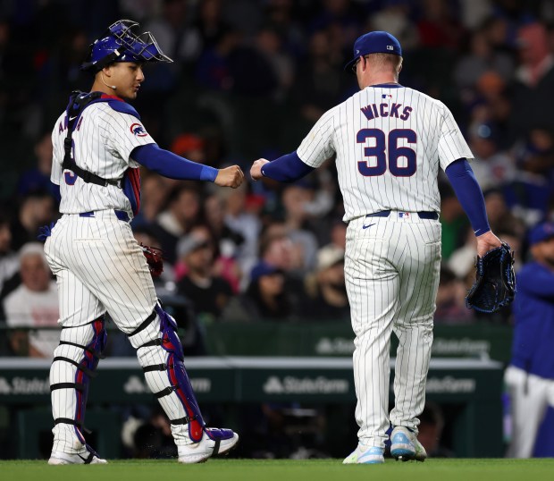 Chicago Cubs catcher Miguel Amaya (9) and starting pitcher Jordan Wicks (36) congratulate one another after finishing off the Houston Astros in the sixth inning of a game at Wrigley Field in Chicago on April 23, 2024. (Chris Sweda/Chicago Tribune)