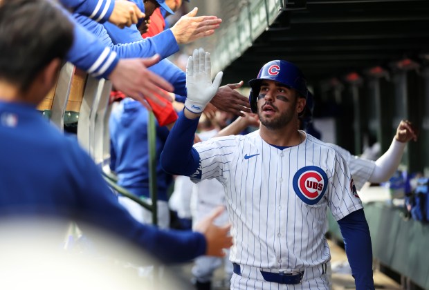 Chicago Cubs rightfielder Mike Tauchman (40) is congratulated by teammates in the dugout after hitting a 3-run home run in the first inning of a game against the Houston Astros at Wrigley Field in Chicago on April 23, 2024. (Chris Sweda/Chicago Tribune)
