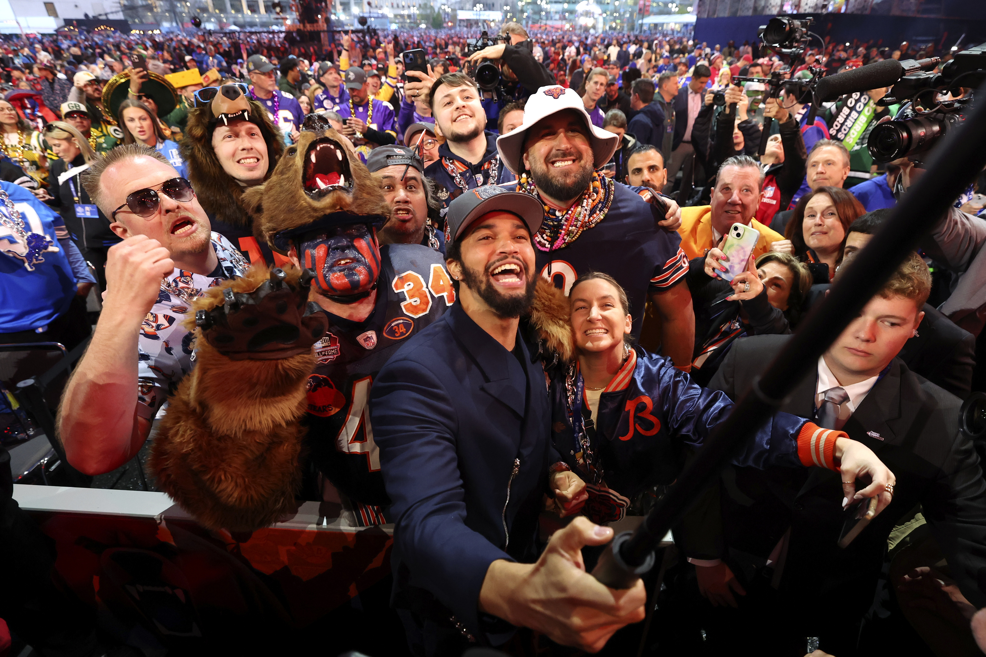 Quarterback Caleb Williams celebrates after being chosen by the Bears...