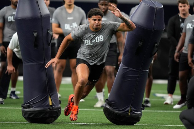Kansas defensive lineman Austin Booker runs a drill during Big 12 NCAA college NFL football pro day Saturday, March 30, 2024, in Frisco, Texas. (AP Photo/LM Otero)