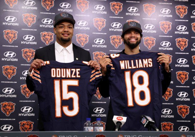 New Bears wide receiver Rome Odunze and quarterback Caleb Williams pose for photographs at Halas Hall on April 26, 2024.  (Chris Sweda/Chicago Tribune)