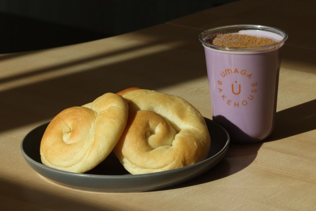 An ensaymada along side an ube horchata drink, at Umaga Bakehouse, a new modern Filipino bakery, in Chicago, on April 25, 2024.  (Antonio Perez/Chicago Tribune)Ube horchata, and bread is sumply ensaymada