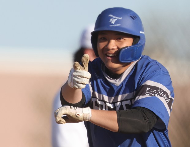 Burlington Central's Solomon Her (9) reacts to cheers from teammates after his home run in the fourth inning against Jacobs a Fox Valley Conference game on Wednesday, April, 24, 2024 in Algonquin. Burlington Central won, 10-6 in 9 innings. H. Rick Bamman / For the Beacon News