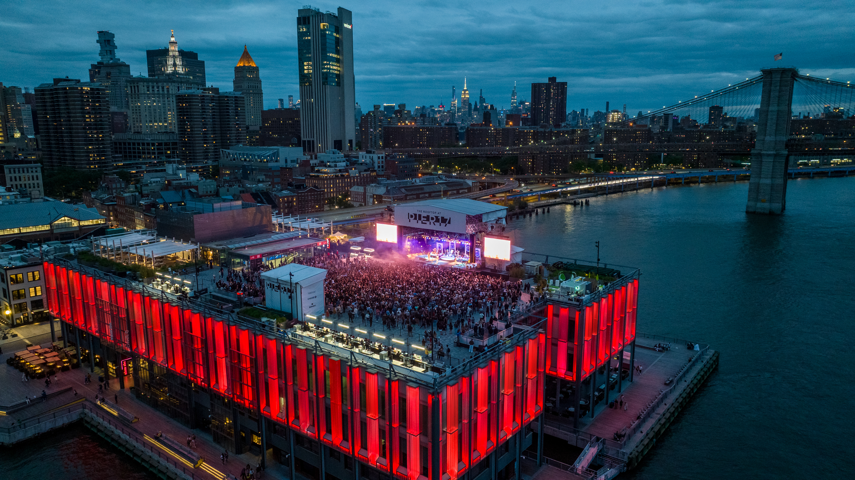 A crowded rooftop stage at Pier 17 in Manhattan.