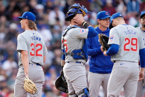 Cubs starting pitcher Ben Brown (32) leaves the field after being relieved by manager Craig Counsell, center right, during the fourth inning against the Red Sox on April 27, 2024, at Fenway Park. (AP Photo/Michael Dwyer)