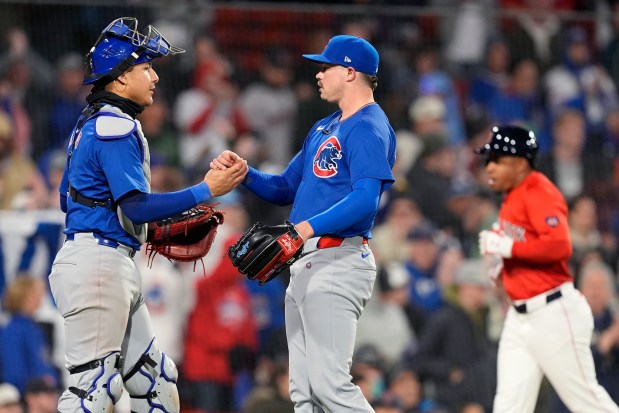 Cubs pitcher Keegan Thompson, center, and catcher Miguel Amaya celebrate after a 9-4 win against the Red Sox on Friday, April 26, 2024, in Boston. (Michael Dwyer/AP)