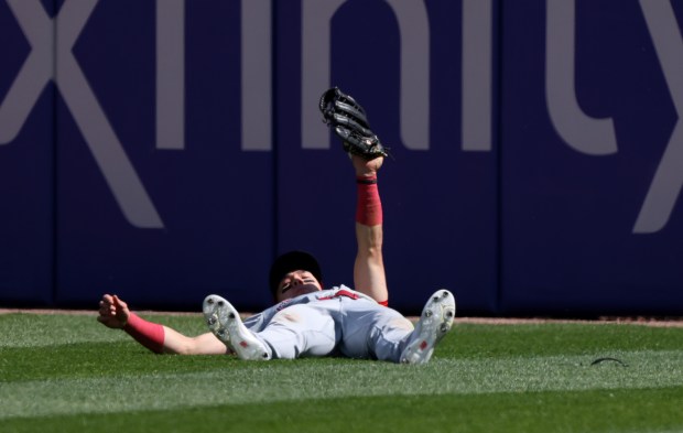 Reds right fielder Stuart Fairchild lifts his glove after diving to catch a ball from White Sox designated hitter Gavin Sheets in the fourth inning on April 13, 2024, at Guaranteed Rate Field. (John J. Kim/Chicago Tribune)