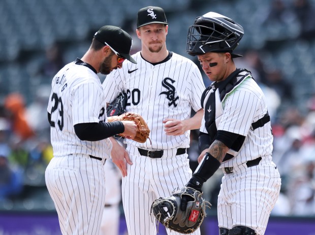 Chicago White Sox shortstop Paul DeJong (29) and Chicago White Sox catcher Korey Lee (26) speak to Chicago White Sox starting pitcher Erick Fedde (20) at the mound during the fourth inning of the game against the Detroit Tigers at Guaranteed Rate Field in Chicago on March 31, 2024. (Eileen T. Meslar/Chicago Tribune)