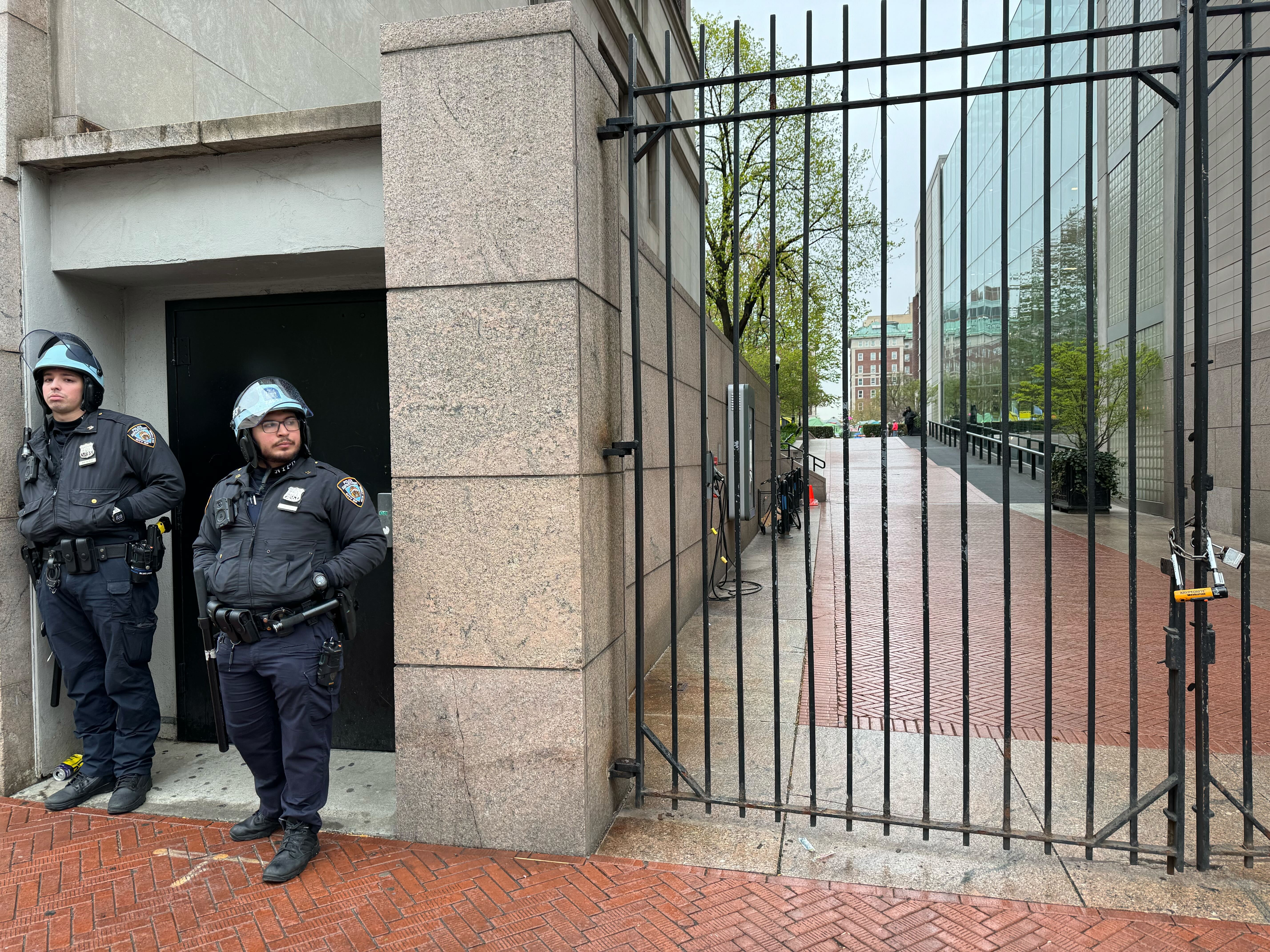 A photo of police officers and locked gates at Columbia.