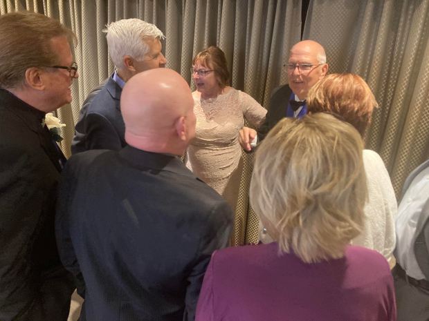Legendary and now-retired WGN meteorologist Tom Skilling, facing forward, talks to former West Aurora High School classmates after he was inducted into the Fox Valley Arts Hall of Fame on Friday (Denise Crosby)