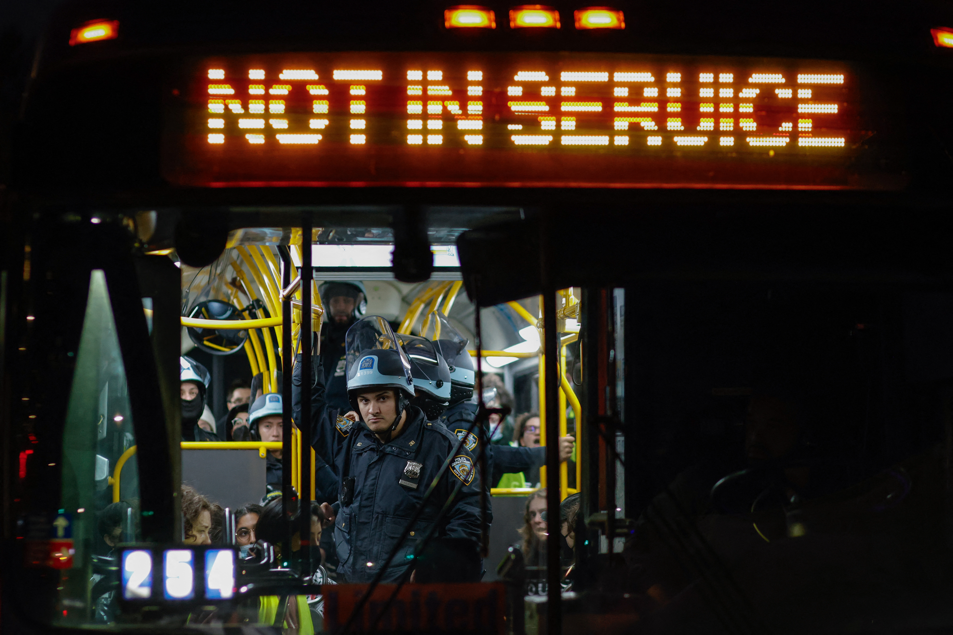 cops on a bus full of protesters