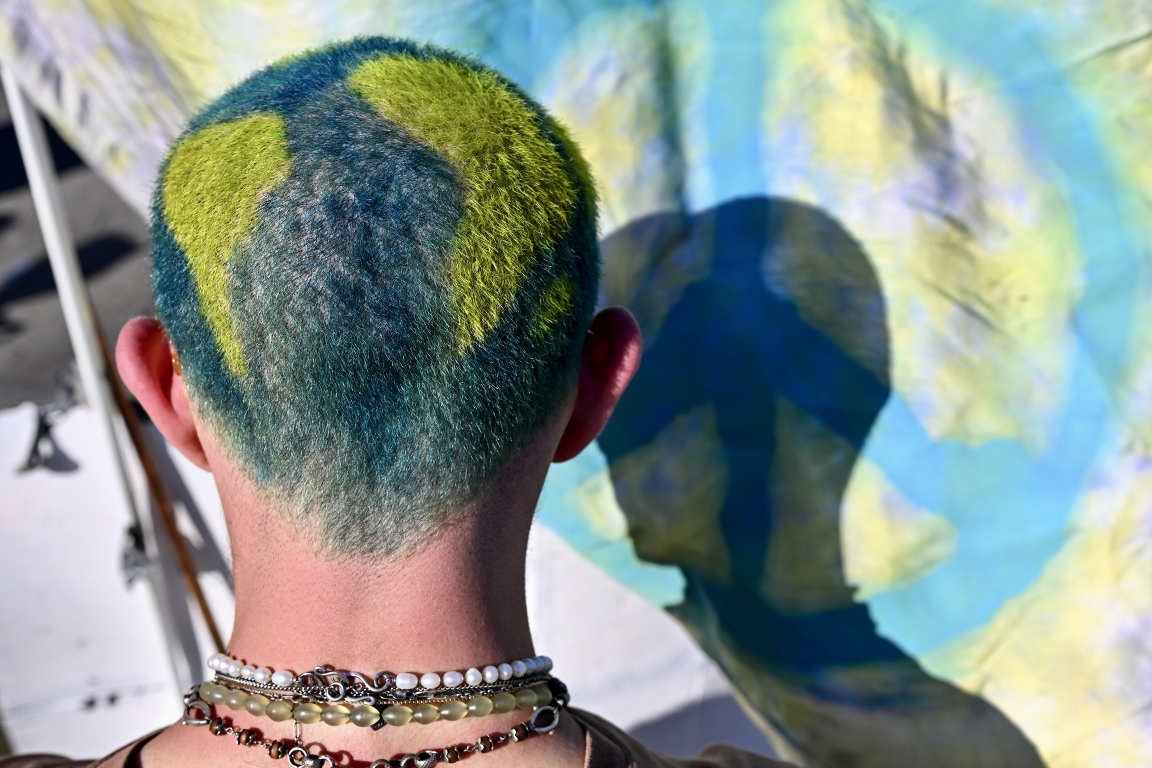 A person with hair dyed the colors of Earth.