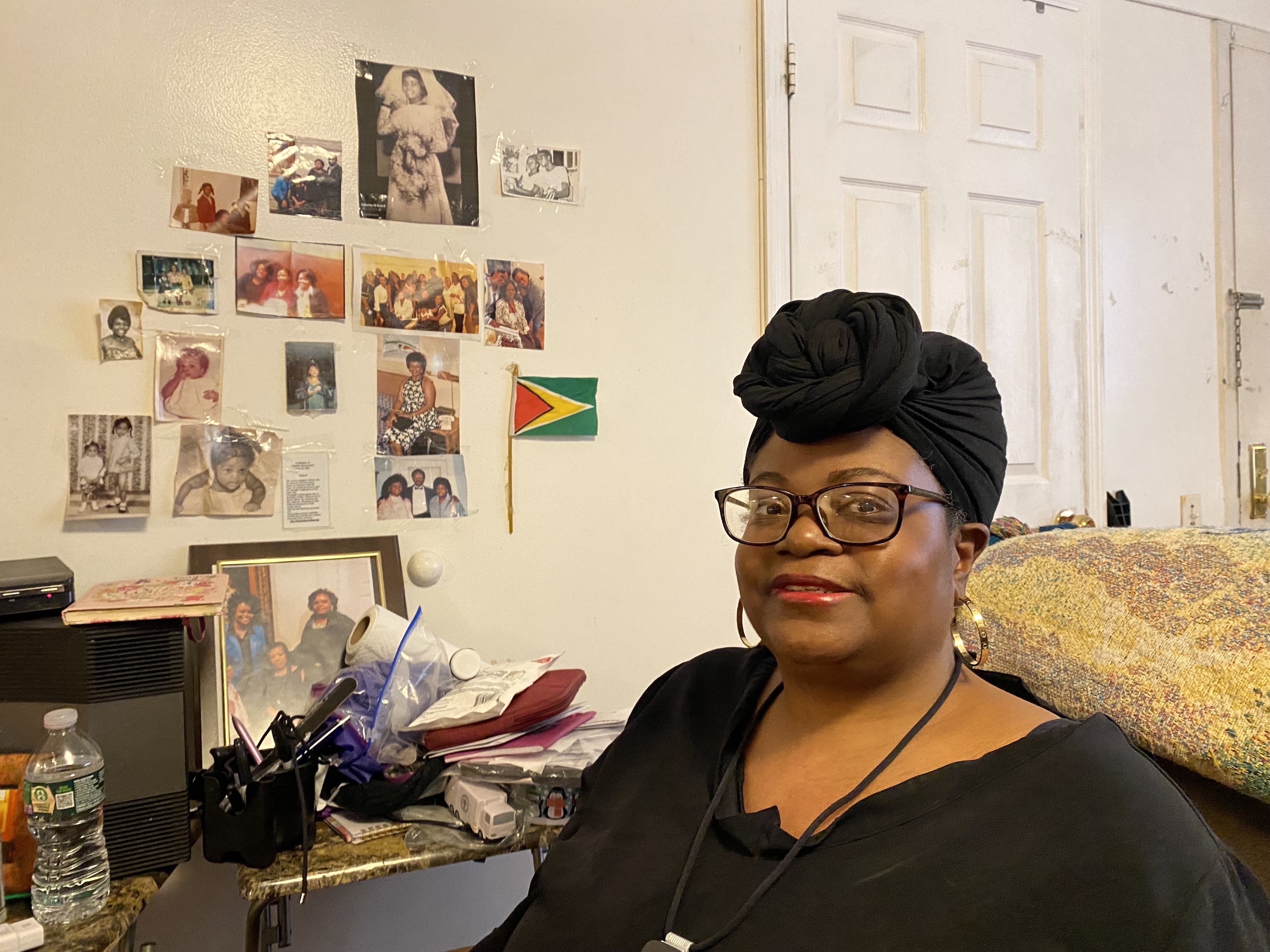 Colette Baird, 52, sits inside of her Bronx apartment, where shes hung pictures on the wall of her family.