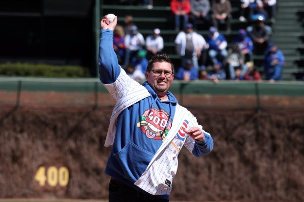 Beau Thompson, who has collected one million Cubs cards, throws out the ceremonial first pitch before a game against the Dodgers on April 5, 2024, at Wrigley Field. (Terrence Antonio James/Chicago Tribune)