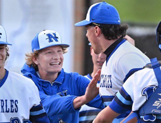 St. Charles North starting pitcher, Keaton Reinke (6. Left) celebrates with reliever, George Gouriotis (8) at the end of Monday's game against St. Charles East, April 29, 2024. St. Charles North won the game, 10-1. (Brian O'Mahoney for the The Beacon-News)