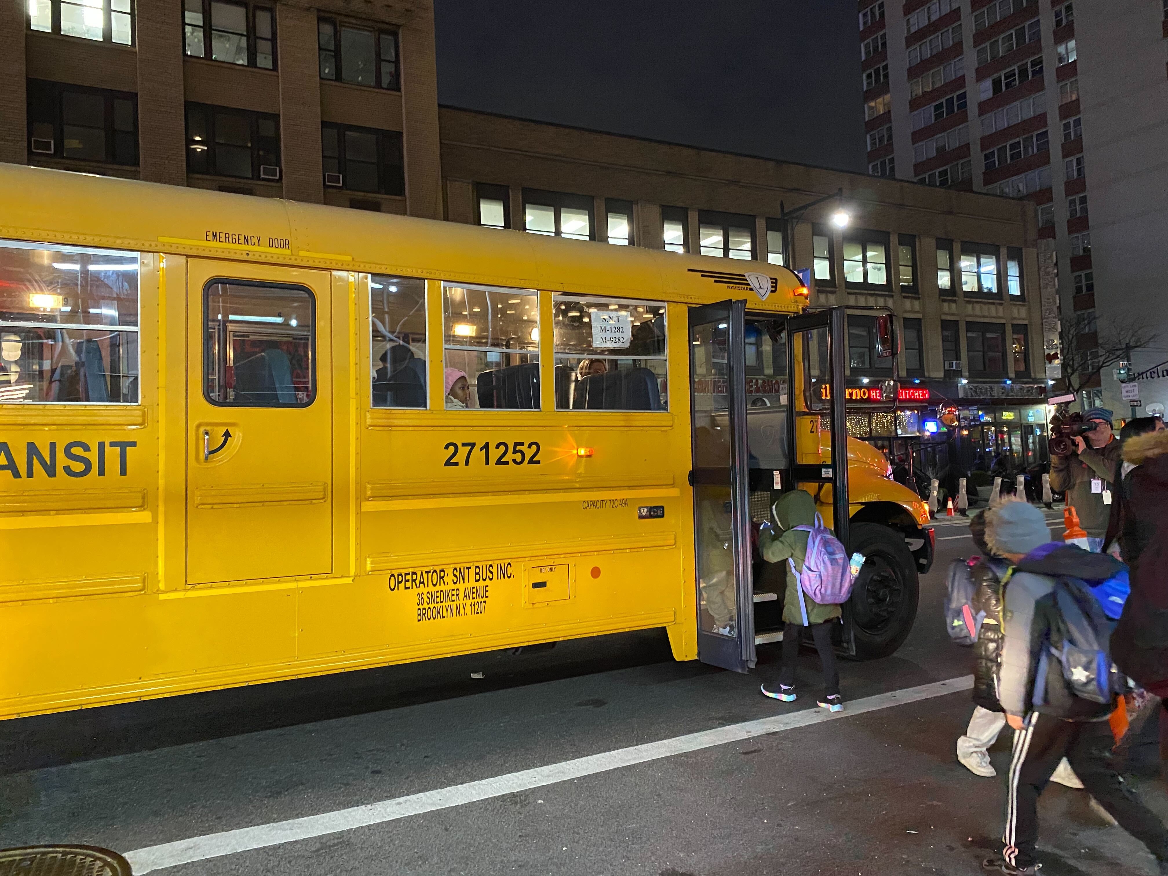 Migrant children seen boarding a school bus outside the Row Hotel in Midtown Manhattan on Jan. 9, 2024.
